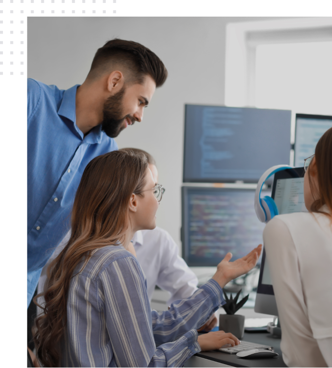 IT staffing team working on a project and looking at a computer screen