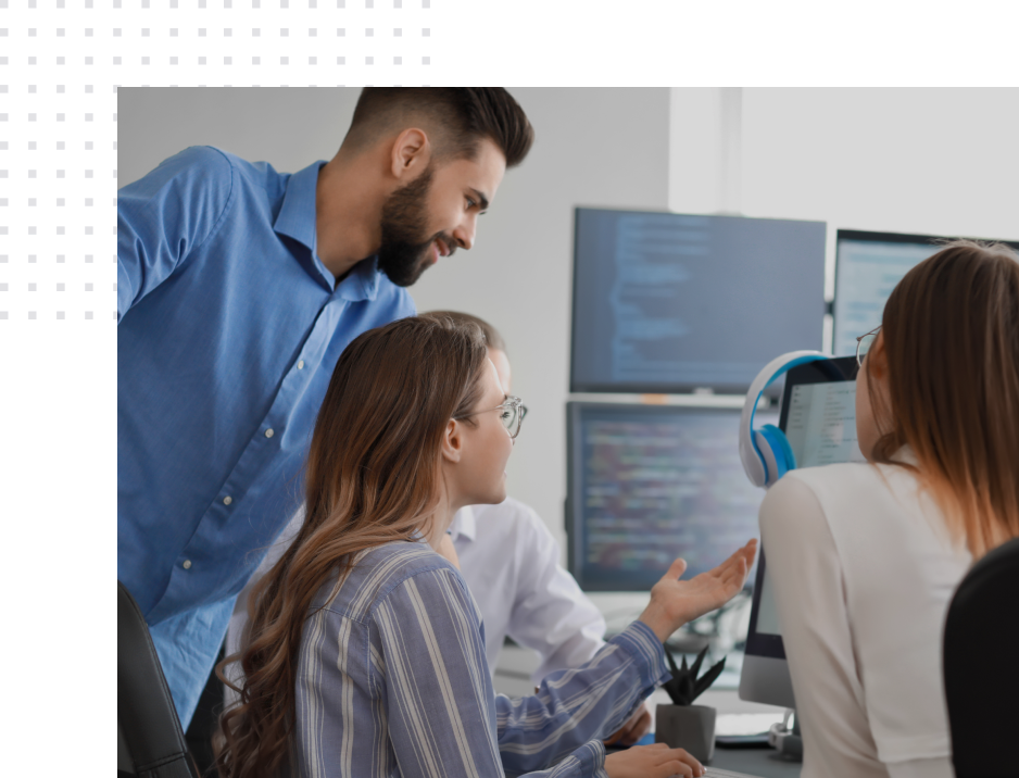 IT staffing team working on a project and looking at a computer screen, big image