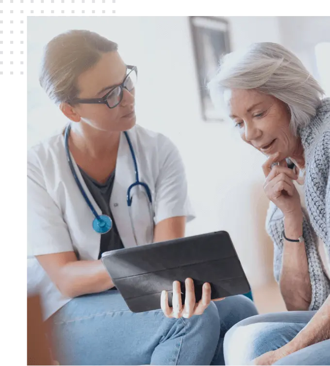 Doctor and patient look at the tablet and discuss